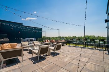 A patio with furniture and string lights.